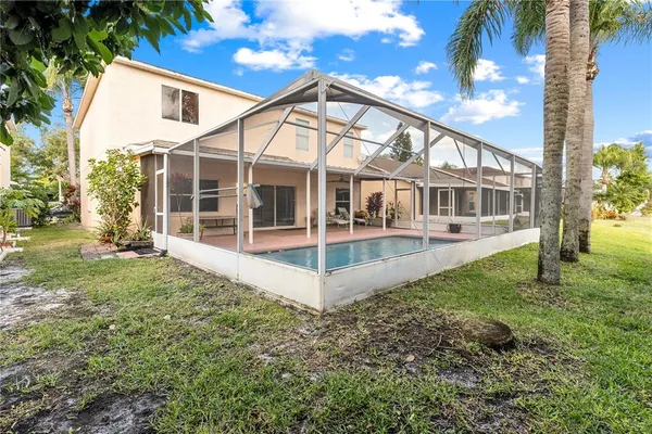 a sign that is sitting in front of a tree