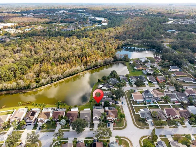 an aerial view of residential houses with outdoor space and swimming pool