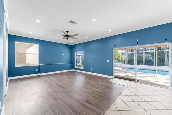 a view of an empty room with chandelier and a window