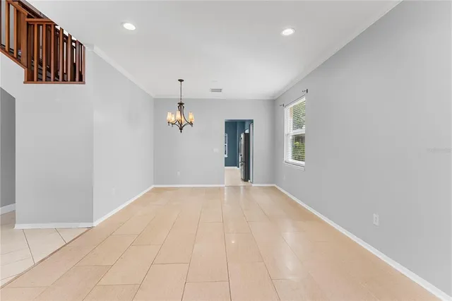 a kitchen with granite countertop a refrigerator and a stove top oven