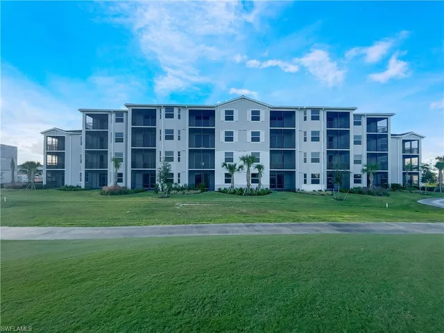 a view of a field with grass and trees