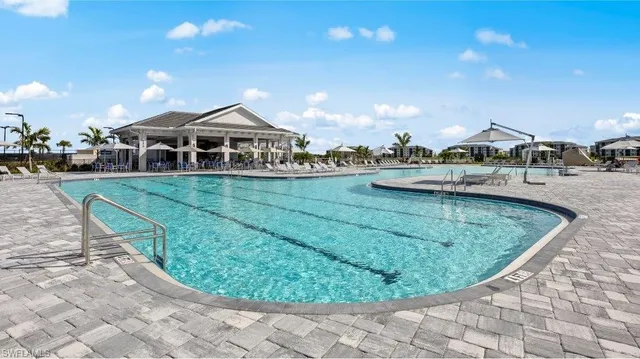 an aerial view of a house with outdoor space swimming pool and ocean view