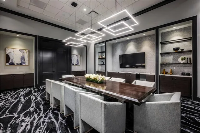 a living room with furniture a large mirror and a chandelier