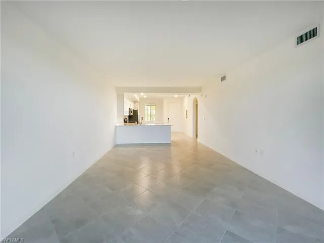 a view of an empty room and a window