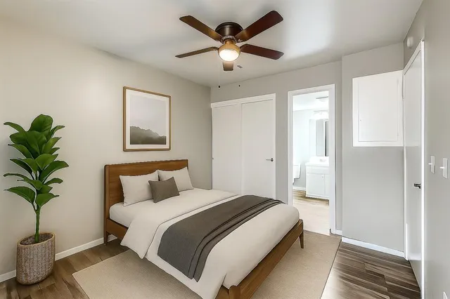 a bedroom with a bed and a potted plant