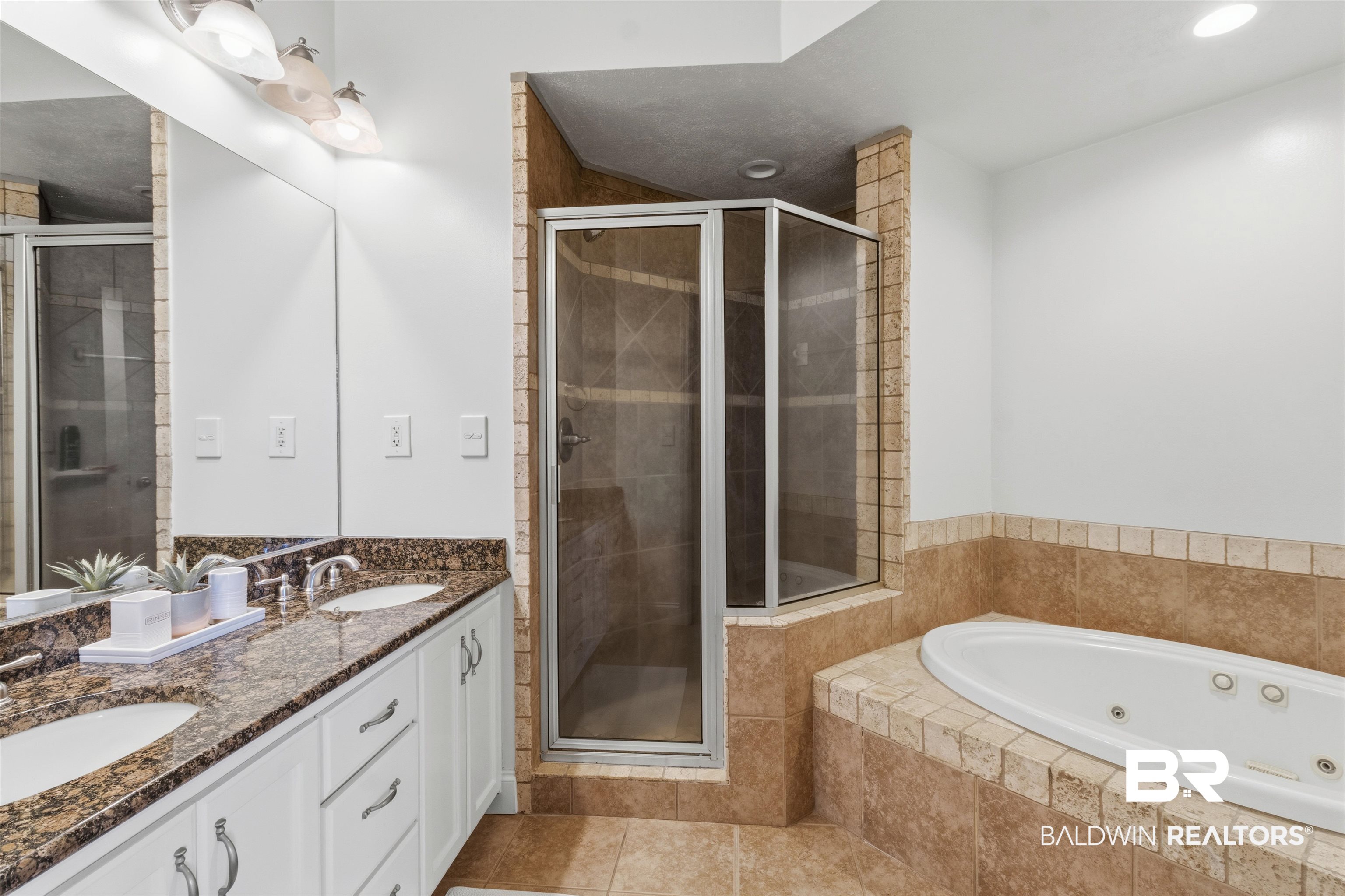 3564 Bayou Road, Unit 203 Orange Beach, AL 36561 - Photo 22 of 53 Bathroom featuring a dual vanity with granite countertops, a tiled walk-in shower with a glass enclosure, a built-in jetted tub, and tile flooring