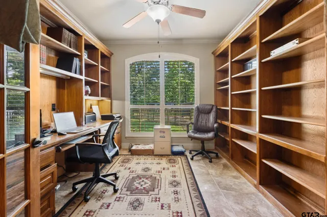 a view of a workspace with furniture and a window