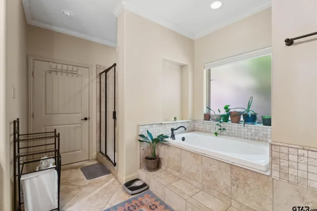 a bathroom with a tub sink and mirror