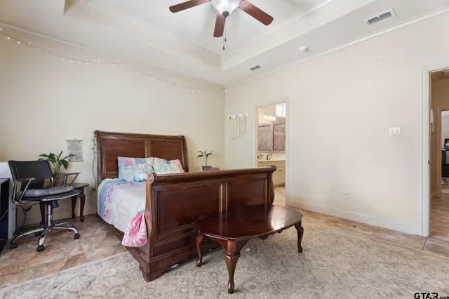 a bedroom with a bed and a chandelier