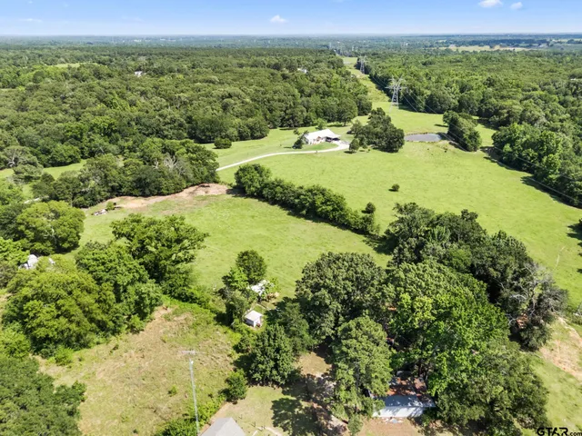 an aerial view of a houses with a yard