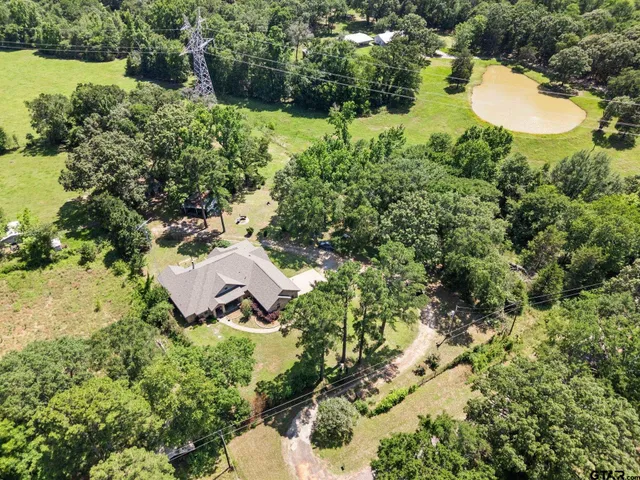 a view of a house with a yard and lake