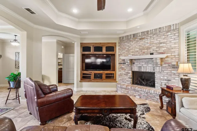 a living room with furniture a flat screen tv and a fireplace