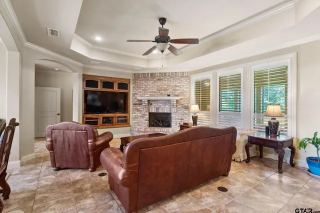 a living room with furniture a fireplace and a flat screen tv