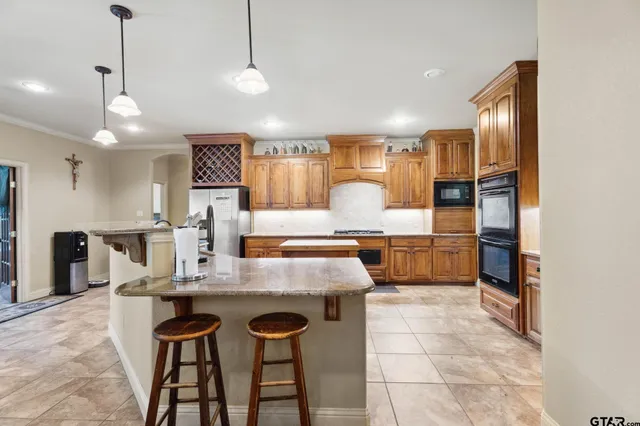 a large kitchen with a table and chairs