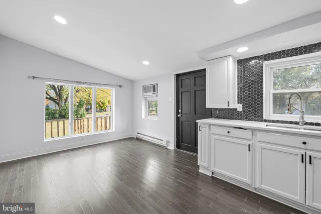 a view of a kitchen with a sink and a large window