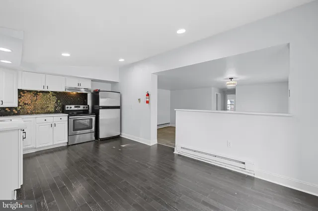 a view of kitchen with refrigerator microwave and stove