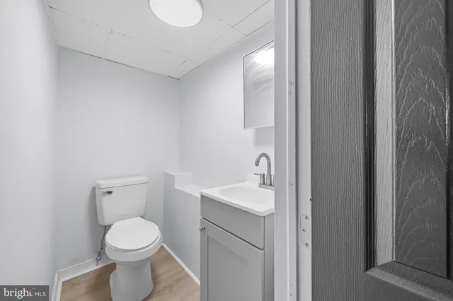 a bathroom with a toilet a sink and mirror