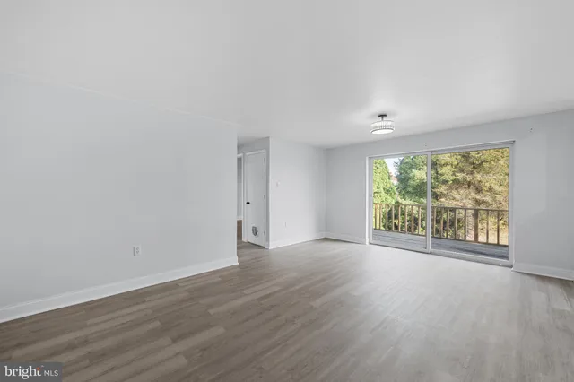a front view of a house with a garden and trees