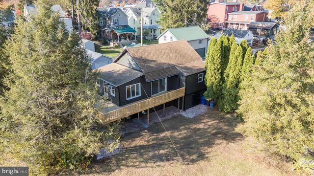 a view of a house with a yard and sitting area