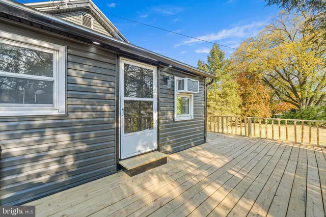 a view of wooden house with a large window