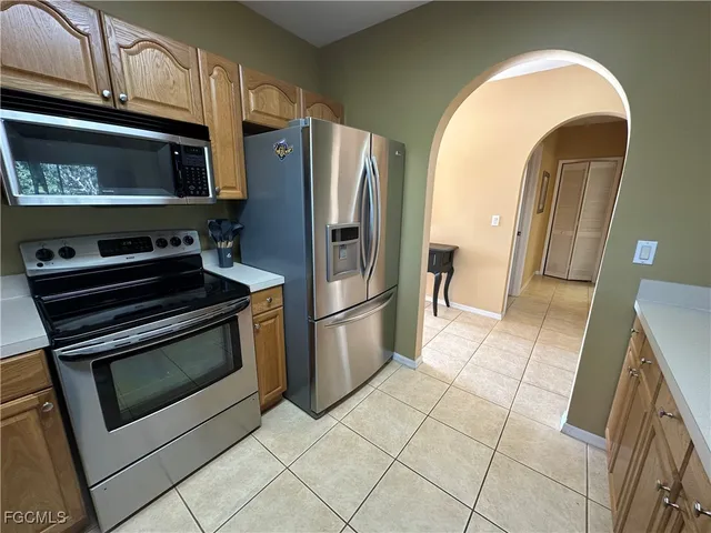 a kitchen with stainless steel appliances granite countertop a stove microwave and refrigerator