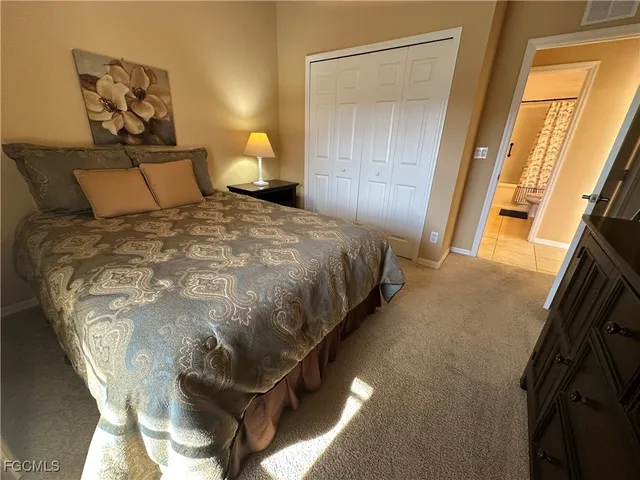 a bedroom with a bed and a mirror