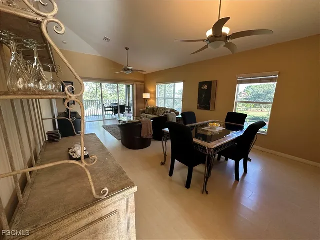 a living room with furniture a flat screen tv and a large window