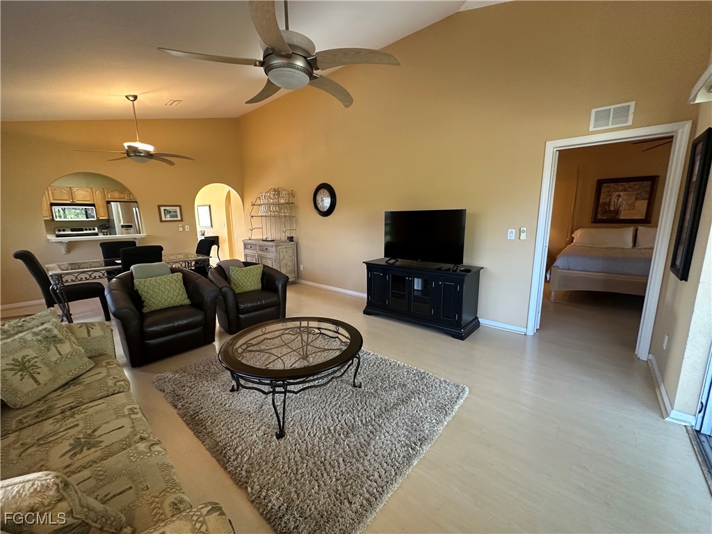 2280 Somerset Ridge Drive, Unit 204 Lehigh Acres, FL 33973 - Photo 24 of 41 a living room with furniture a rug and a flat screen tv