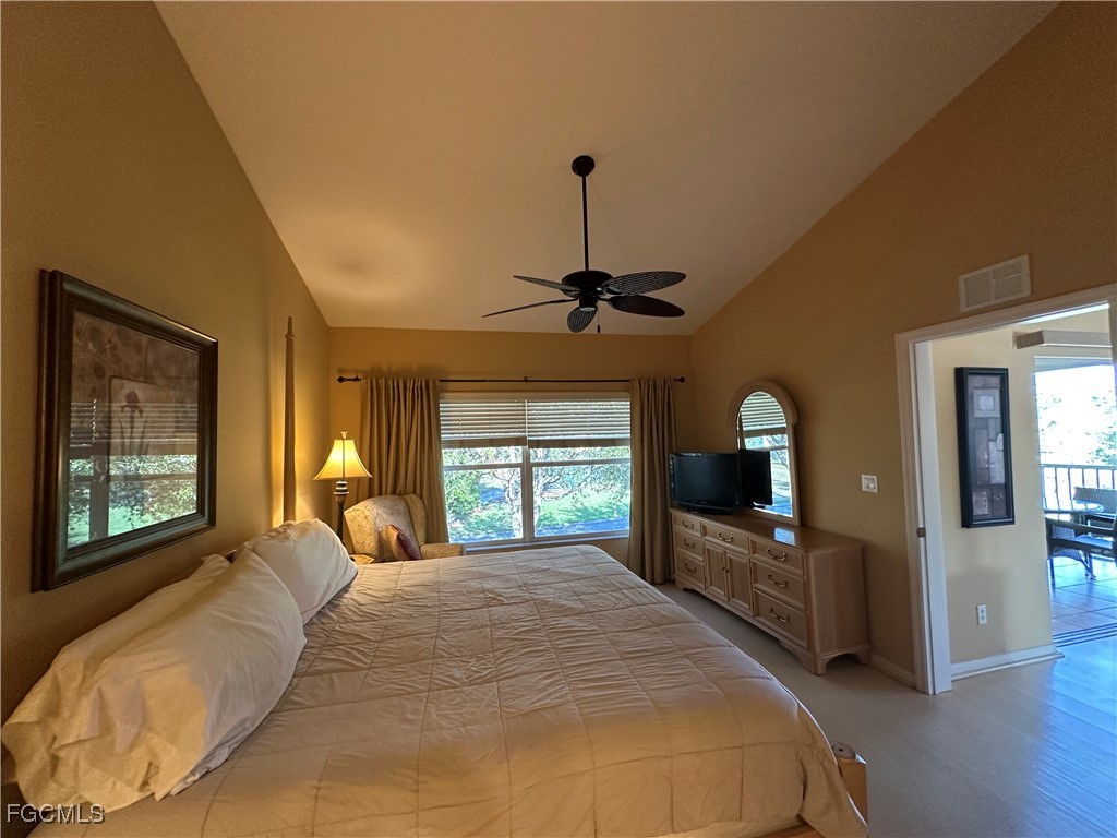 2280 Somerset Ridge Drive, Unit 204 Lehigh Acres, FL 33973 - Photo 25 of 41 a bedroom with a bed large window with wooden floor