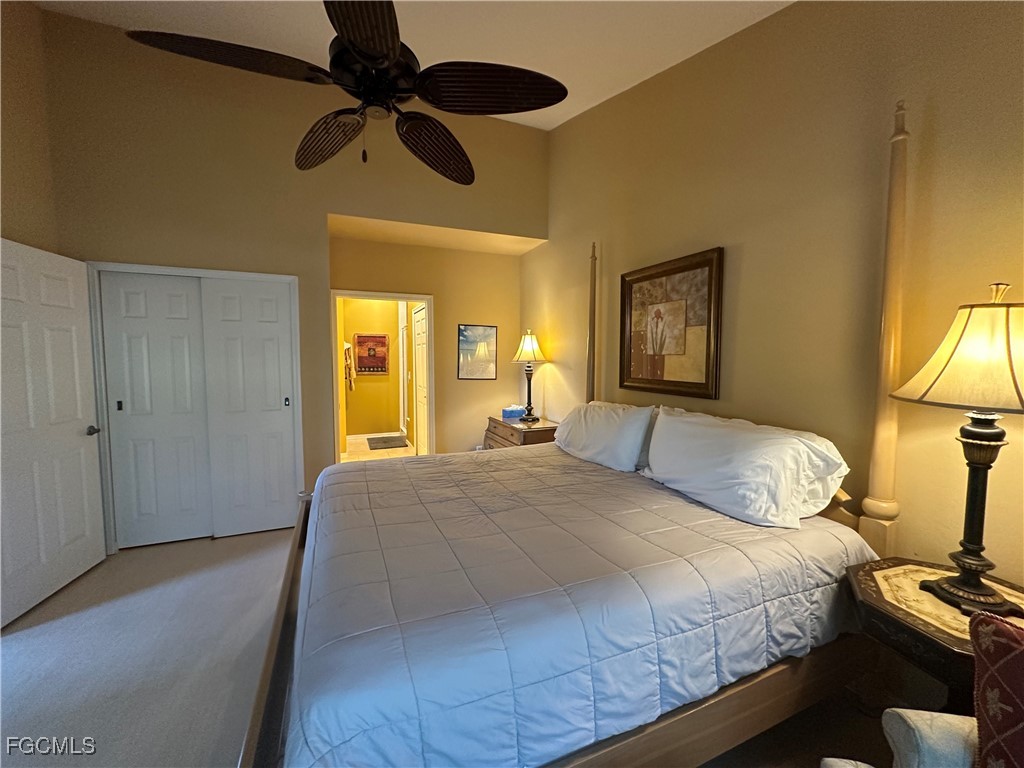 2280 Somerset Ridge Drive, Unit 204 Lehigh Acres, FL 33973 - Photo 26 of 41 a bedroom with a bed and a chandelier