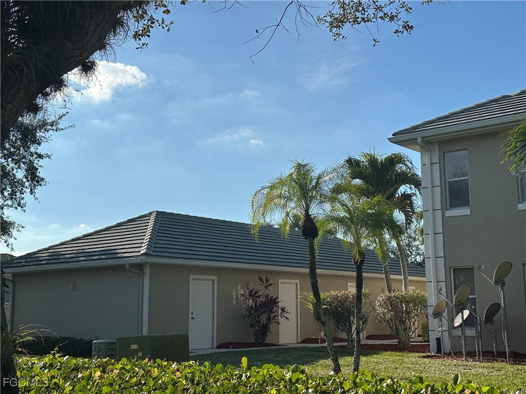 2280 Somerset Ridge Drive, Unit 204 Lehigh Acres, FL 33973 - Photo 36 of 41 a front view of a house with garden