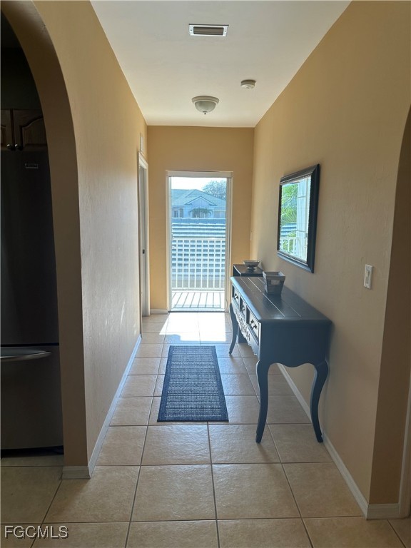 2280 Somerset Ridge Drive, Unit 204 Lehigh Acres, FL 33973 - Photo 5 of 41 a hallway with a washer and dryer