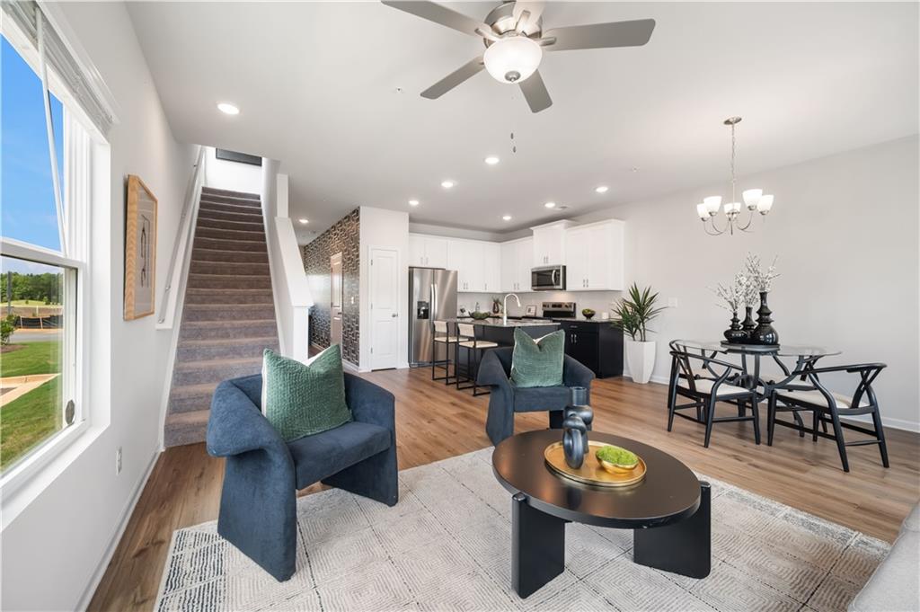 9437 Maple Grove Lane Jonesboro, GA 30238 - Photo 16 of 32 a living room with furniture kitchen view and a large window