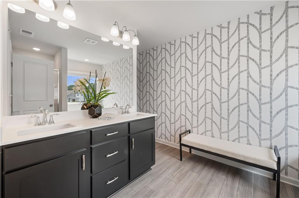 9437 Maple Grove Lane Jonesboro, GA 30238 - Photo 25 of 32 a bathroom with a sink vanity granite and a mirror