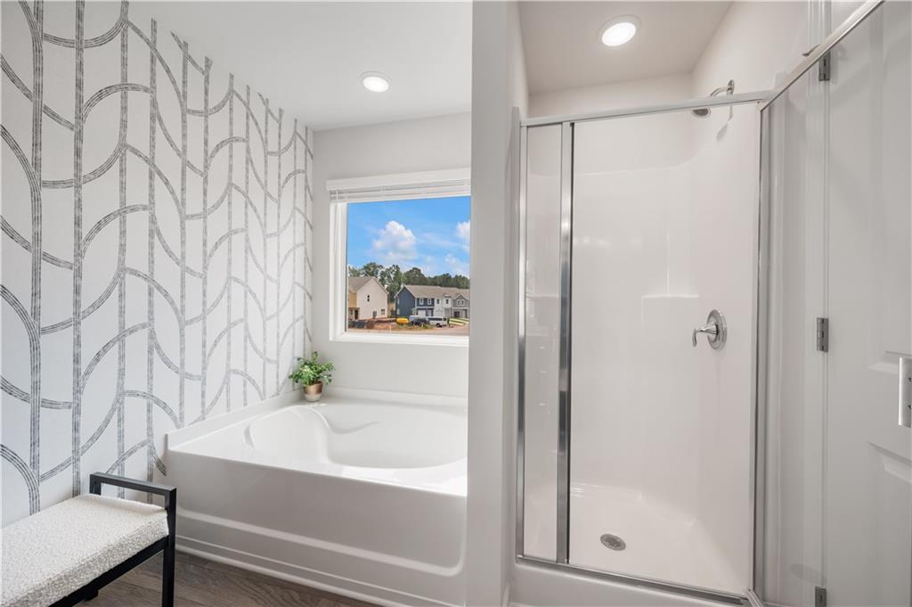 9437 Maple Grove Lane Jonesboro, GA 30238 - Photo 26 of 32 a bathroom with a bathtub and a shower