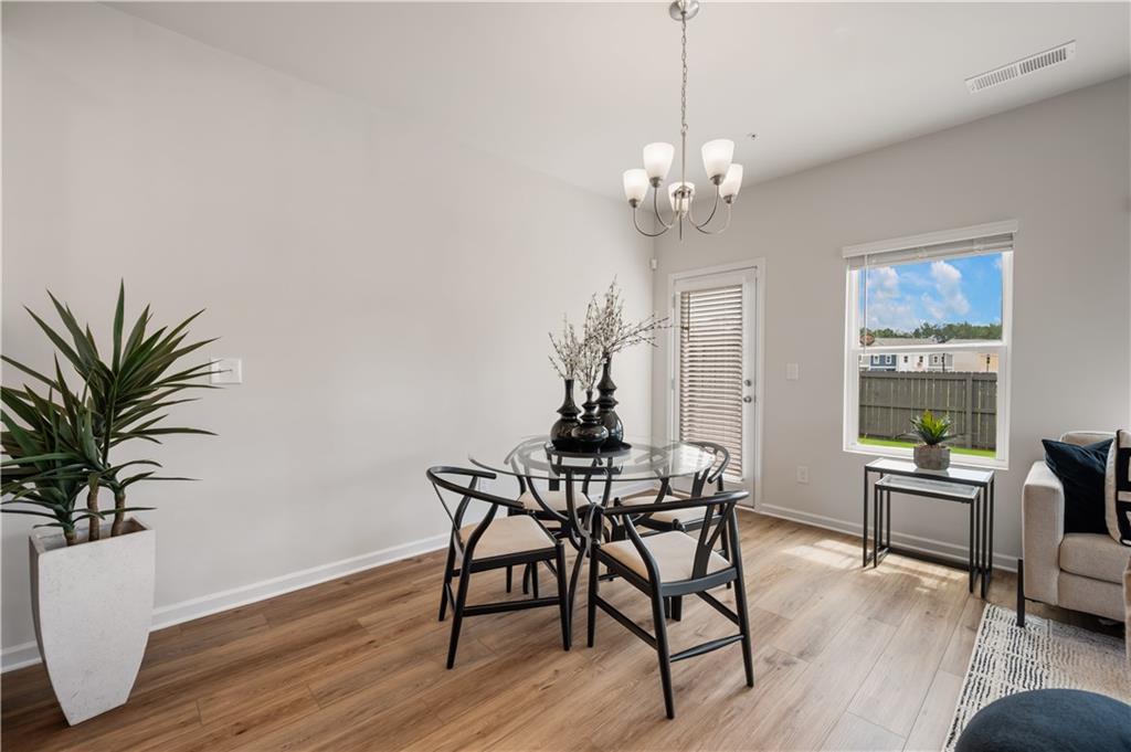 9437 Maple Grove Lane Jonesboro, GA 30238 - Photo 8 of 32 a view of a dining room with furniture window and wooden floor
