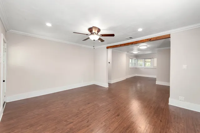 wooden floor in an empty room with a window
