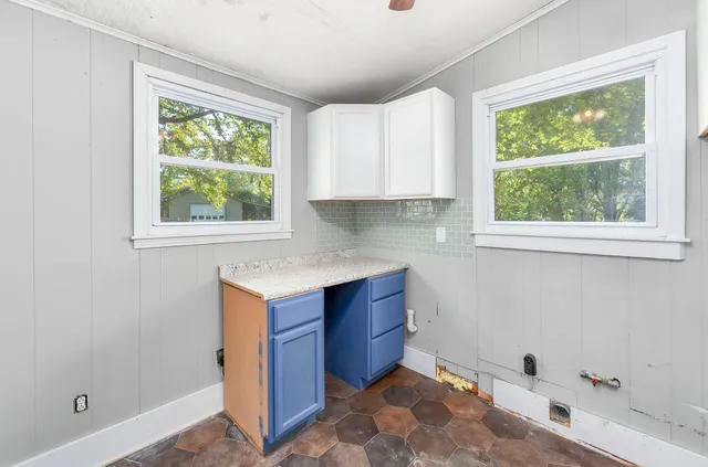 a kitchen with a window and cabinets
