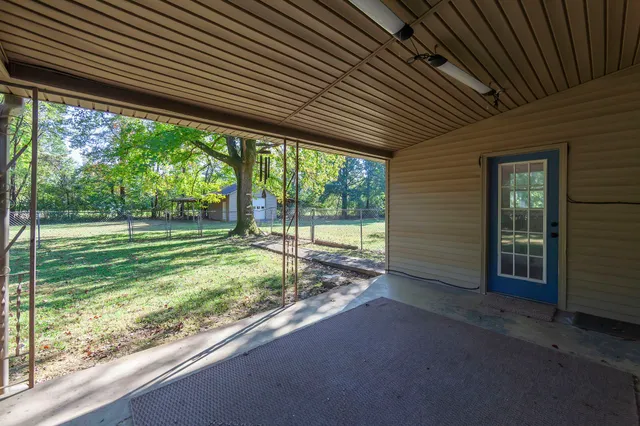 a backyard of a house with a garden and outdoor seating