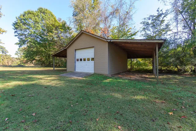 a view of a house with yard and a tree