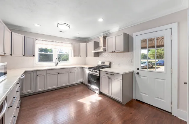 a kitchen with white cabinets and white appliances