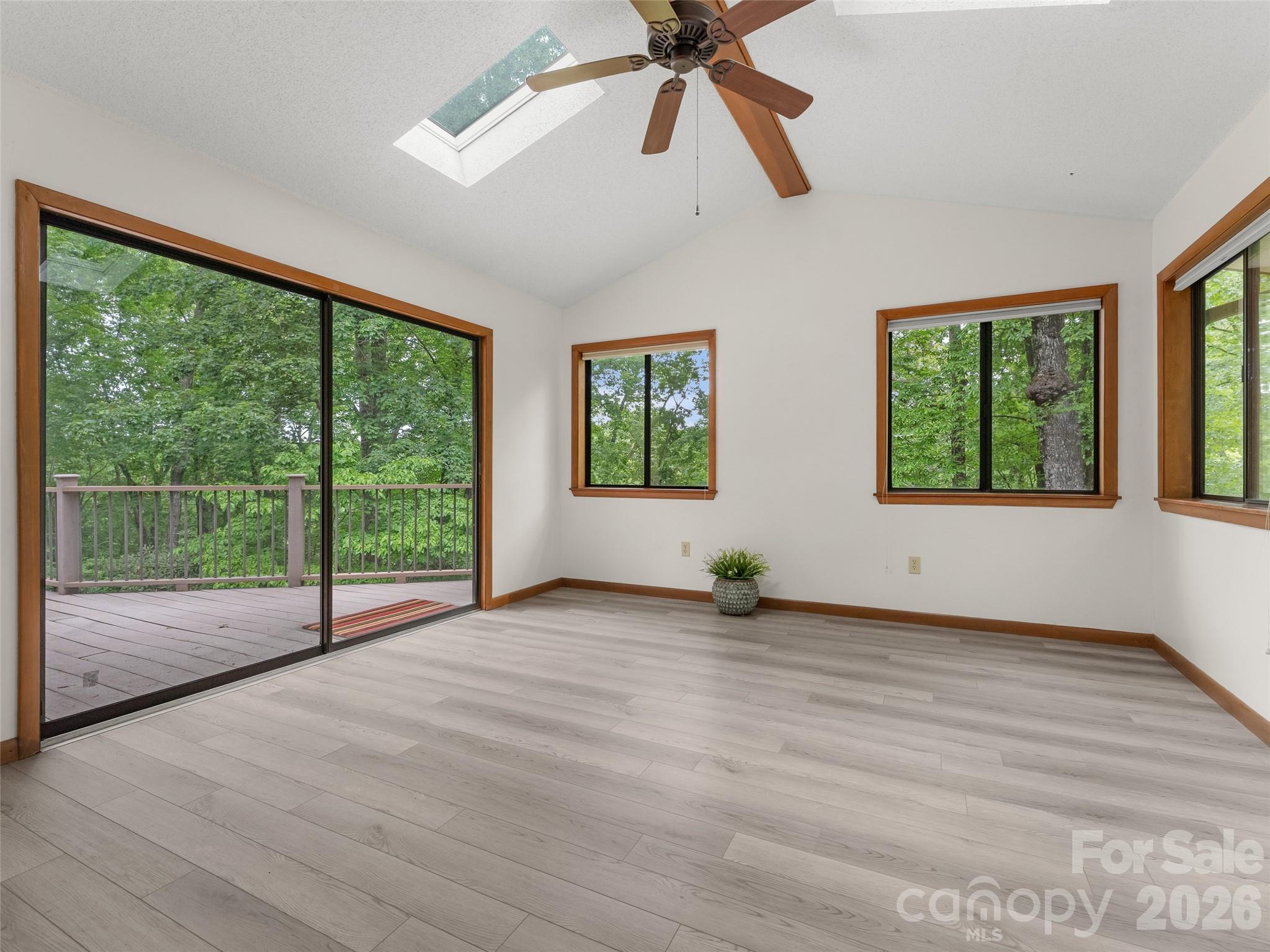 32 Honey Suckle Ridge Road Pisgah Forest, NC 28768 - Photo 11 of 35 a view of an empty room with wooden floor and windows