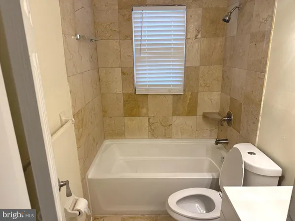 a bathroom with a toilet and a bathtub