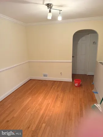 a view of a room with wooden floor