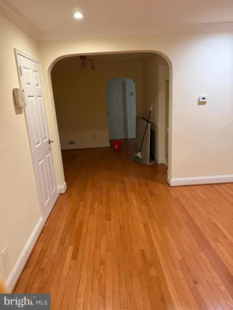 a view of a hallway with wooden floor and stairs