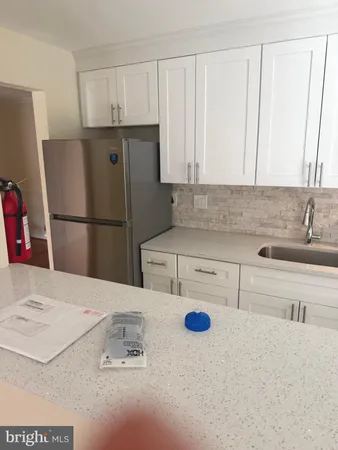 a kitchen with a refrigerator and a sink