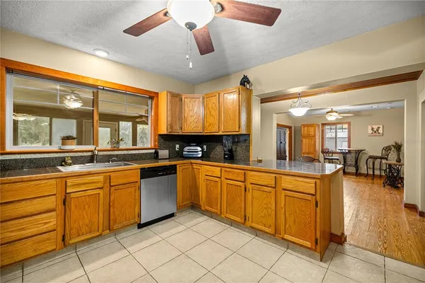 a large kitchen with a large window cabinets and stainless steel appliances