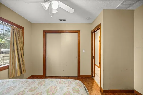 a bedroom with a bed and a window