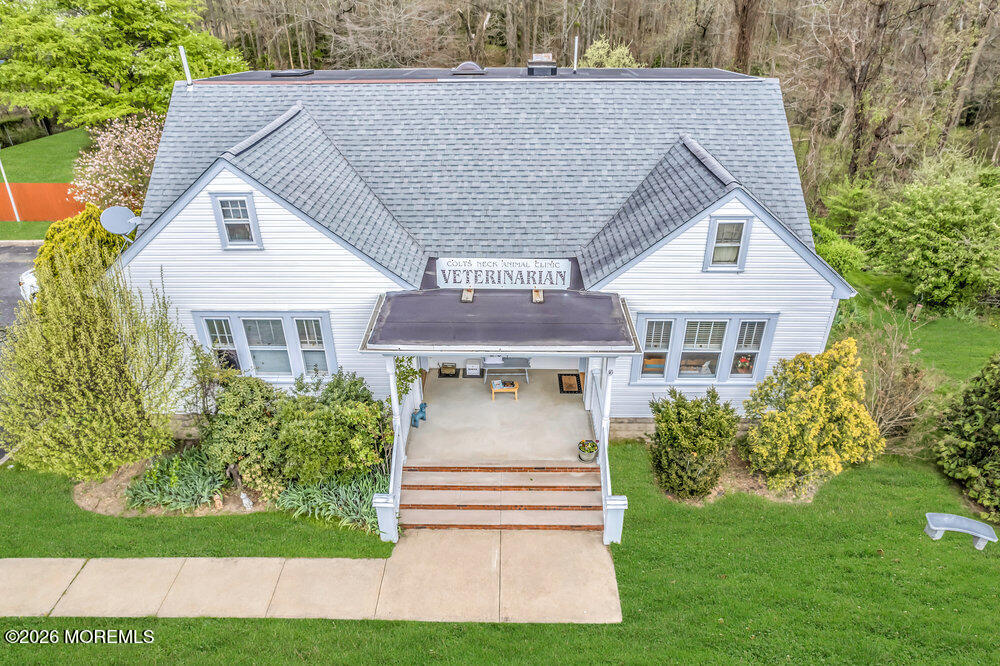 34 State Route Colts Neck, NJ 07722 - Photo 3 of 40 a front view of a house with a yard and potted plants