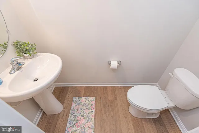 a white toilet sitting next to a bathroom sink